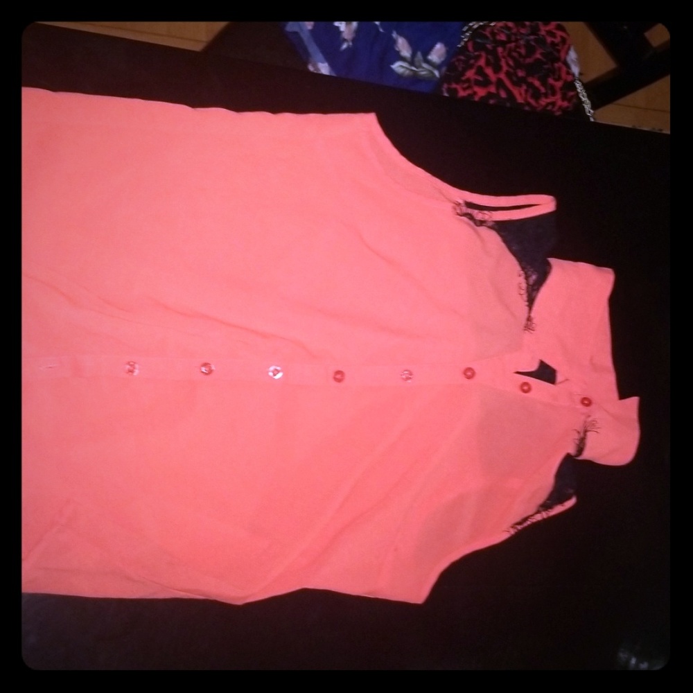 A orange shirt with lace on the back